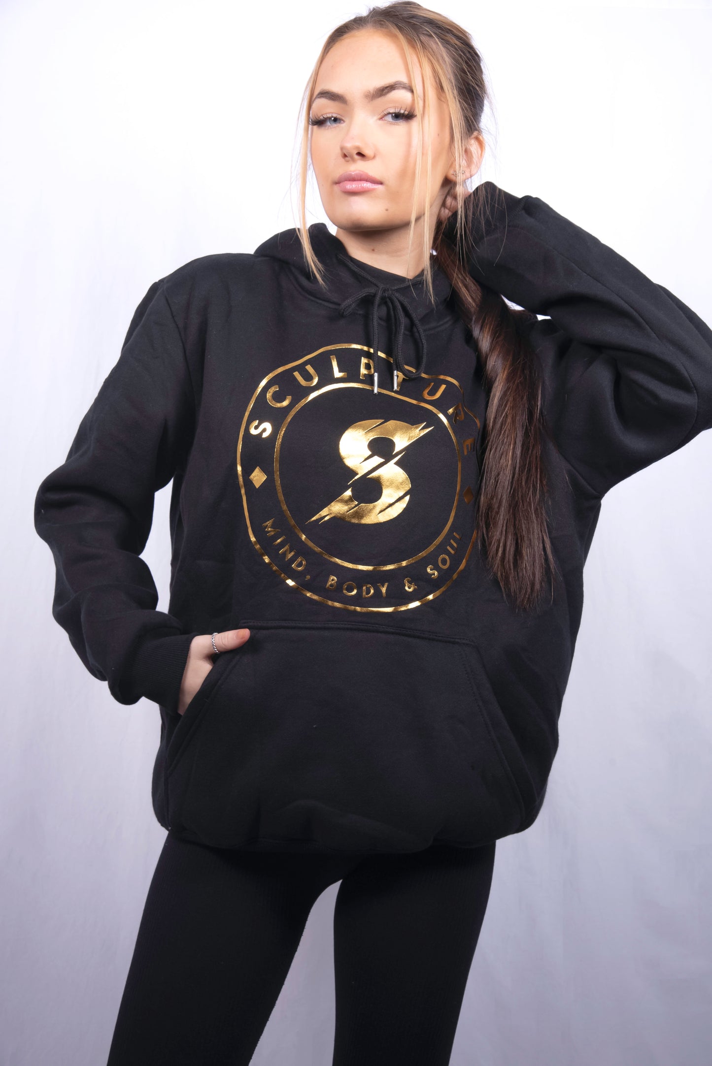 woman wearing black and gold gym activewear hoodie made with 100 percent cotton