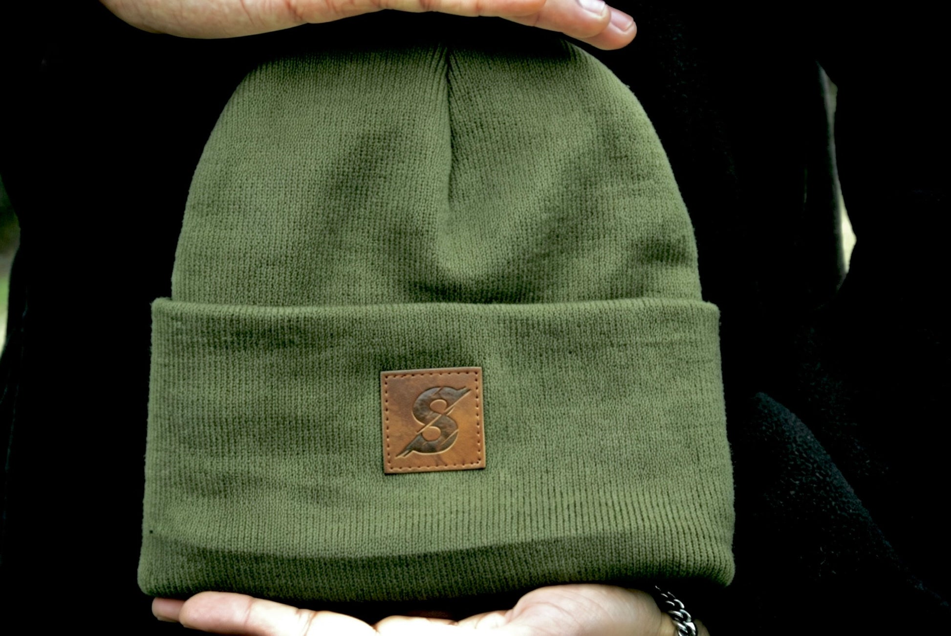 Khaki Green beanie with a brown leather patch with Sculpture Active logo